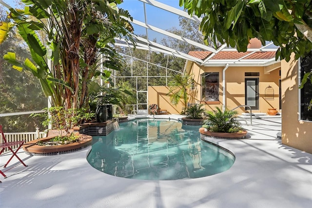 view of swimming pool with glass enclosure and a patio