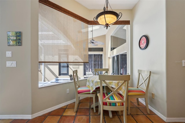 dining area featuring ceiling fan and tile patterned flooring