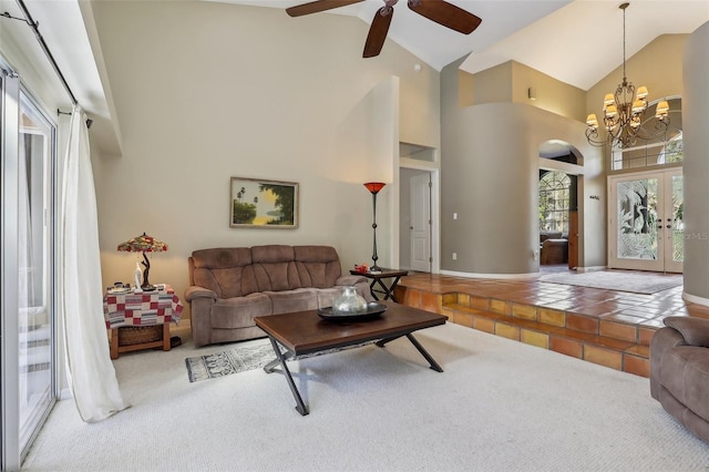 living room featuring ceiling fan with notable chandelier, high vaulted ceiling, and french doors