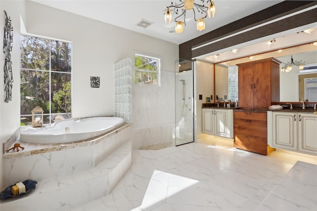 bathroom with independent shower and bath, a chandelier, and vanity