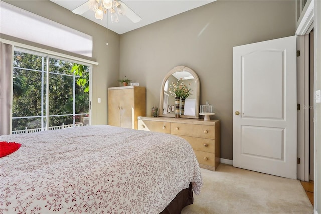 carpeted bedroom featuring ceiling fan and access to outside