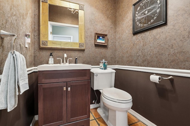 bathroom featuring toilet, vanity, and tile patterned flooring