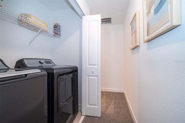 laundry room featuring separate washer and dryer and carpet