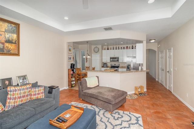 living room featuring a tray ceiling