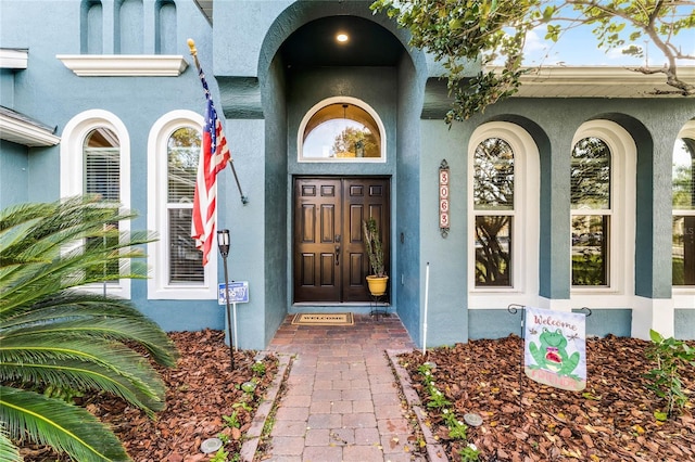 property entrance with stucco siding