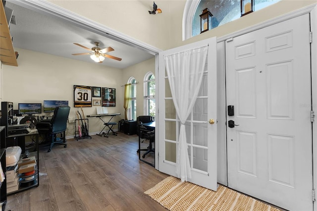 foyer entrance featuring french doors, visible vents, a ceiling fan, wood finished floors, and baseboards