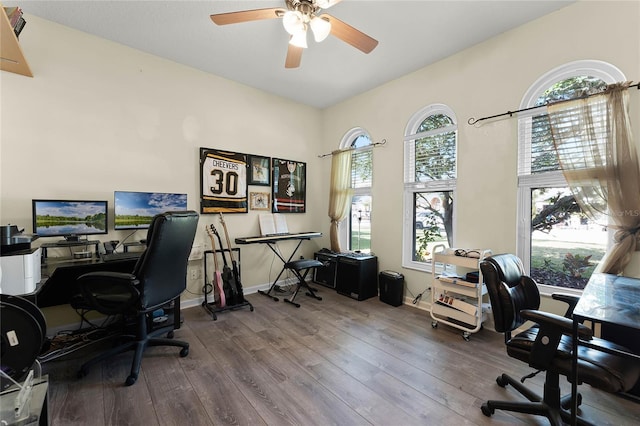 office space featuring ceiling fan, baseboards, and wood finished floors