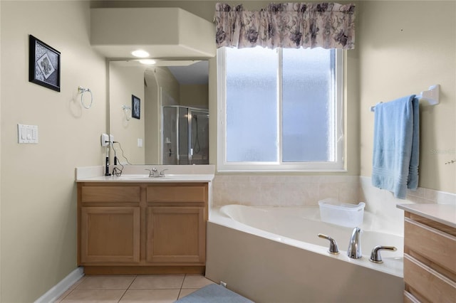 bathroom with a bath, a shower stall, vanity, and tile patterned floors