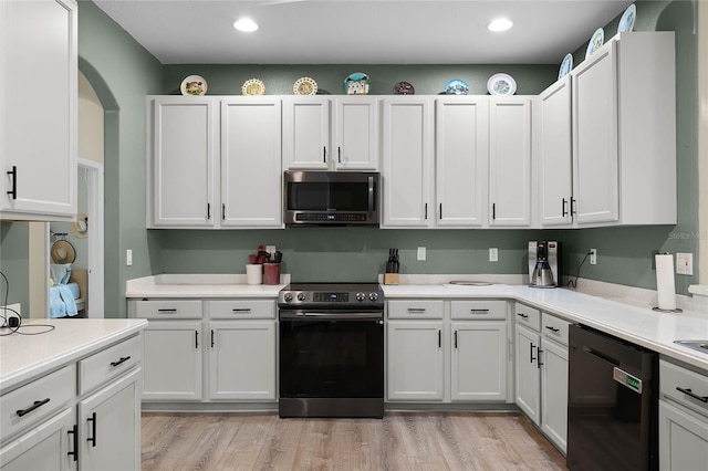 kitchen featuring dishwasher, electric stove, stainless steel microwave, light countertops, and white cabinetry