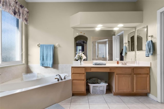 full bathroom with double vanity, a stall shower, a bath, and tile patterned floors