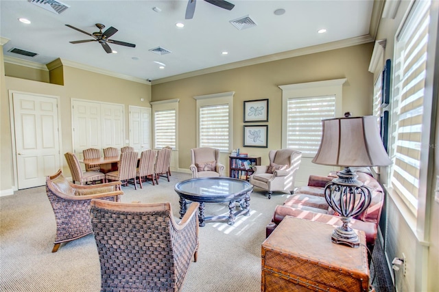 carpeted living room featuring baseboards, visible vents, and a ceiling fan