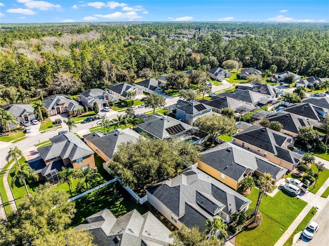 bird's eye view featuring a forest view and a residential view