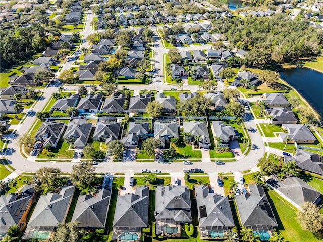 drone / aerial view with a water view and a residential view