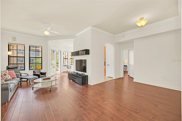 living room with ornamental molding, dark hardwood / wood-style floors, and ceiling fan