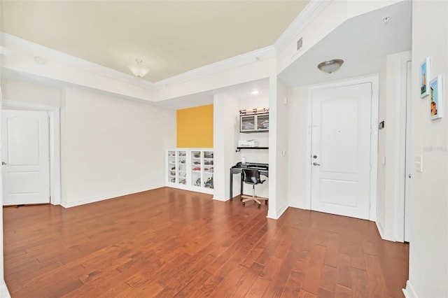 unfurnished living room with ornamental molding and dark wood-type flooring