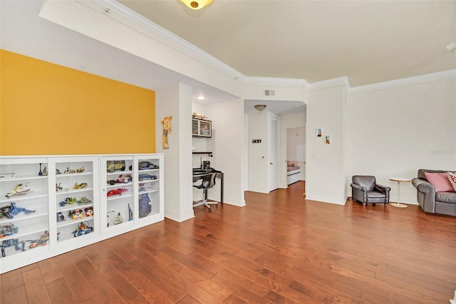 interior space with crown molding and wood-type flooring