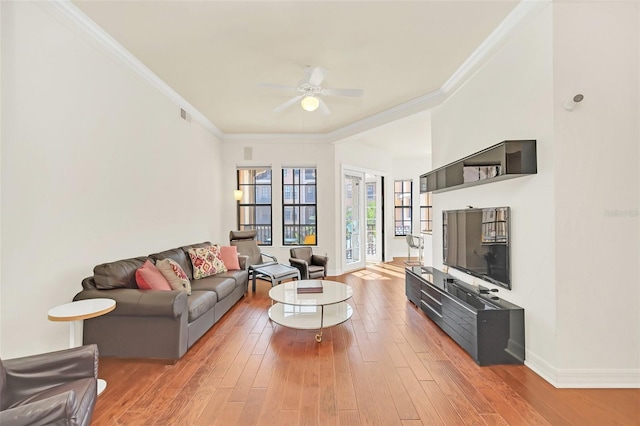 living room featuring hardwood / wood-style flooring, ceiling fan, and ornamental molding