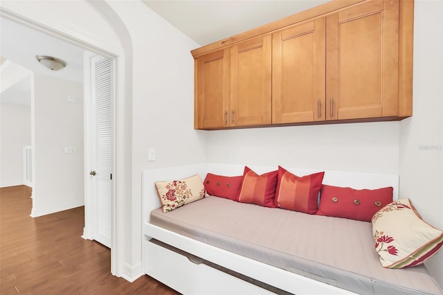 bedroom with dark wood-type flooring