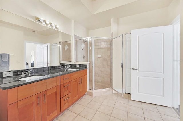 bathroom featuring tile patterned flooring, an enclosed shower, and vanity