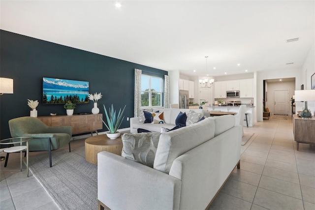 living room featuring a chandelier and light tile patterned floors