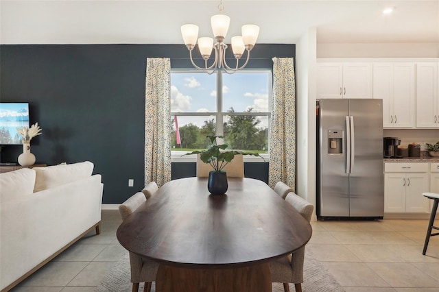 tiled dining area featuring an inviting chandelier