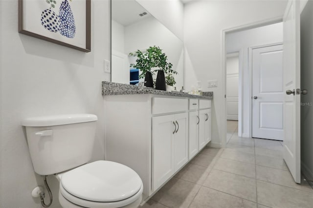 bathroom featuring toilet, tile patterned flooring, and vanity