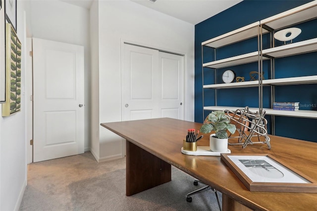 office with built in shelves and carpet flooring