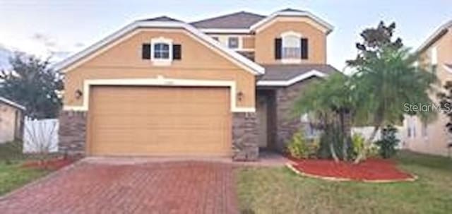 view of front of home with a front yard and a garage