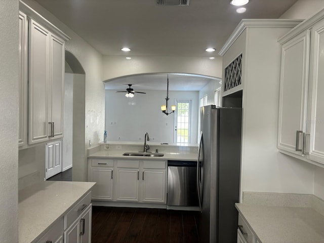 kitchen featuring pendant lighting, sink, white cabinets, dark hardwood / wood-style floors, and stainless steel appliances