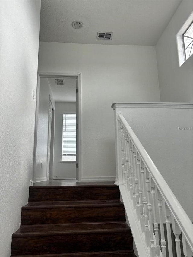 stairs with hardwood / wood-style floors