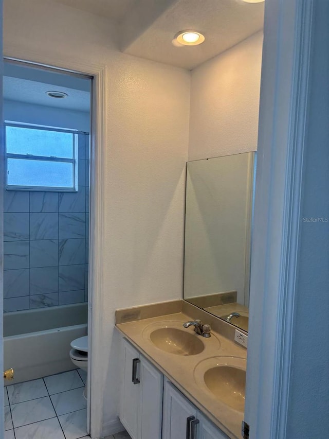 full bathroom with vanity, toilet, tiled shower / bath combo, and tile patterned flooring