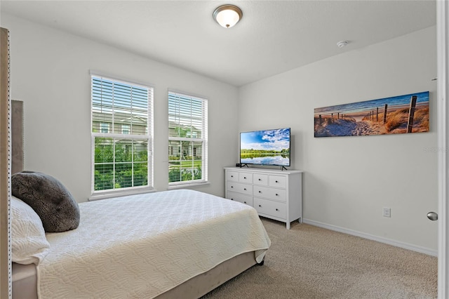 bedroom featuring light carpet