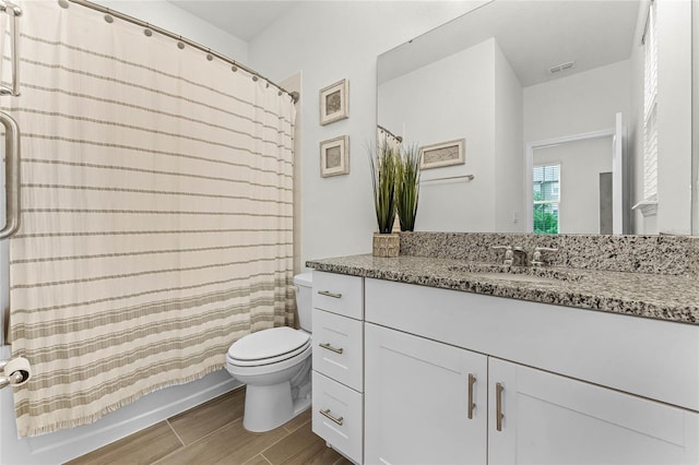 full bathroom featuring toilet, vanity, and shower / bathtub combination with curtain