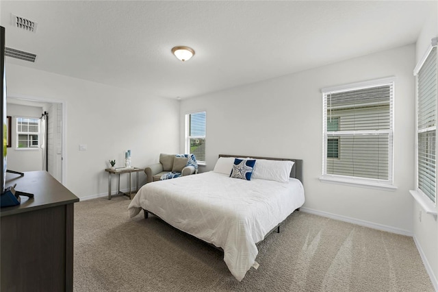 bedroom featuring light carpet