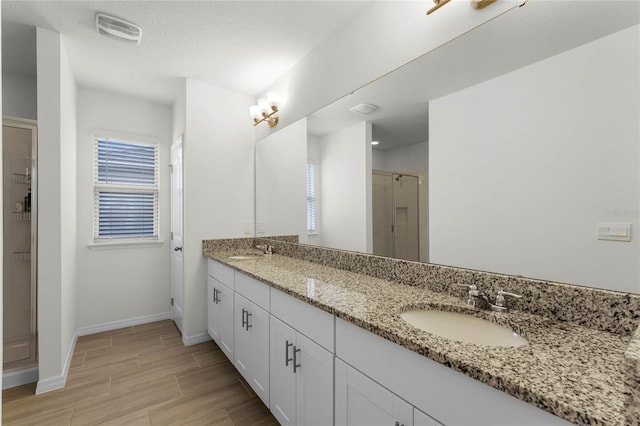 bathroom with an enclosed shower and vanity