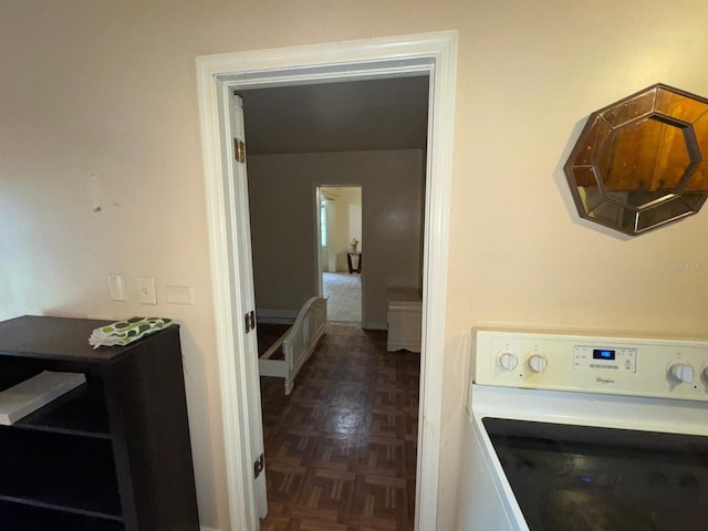 laundry room with washer / clothes dryer and dark parquet flooring