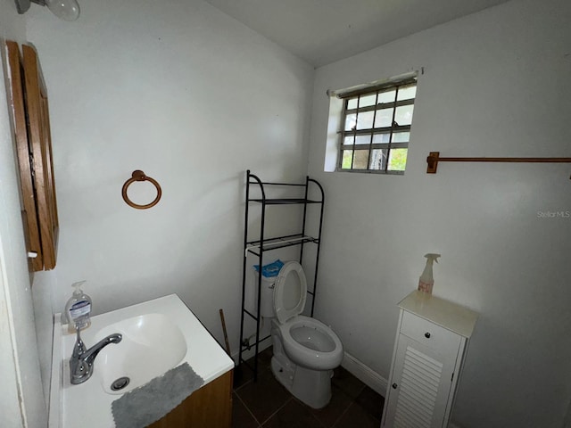 bathroom featuring toilet, tile patterned floors, and vanity