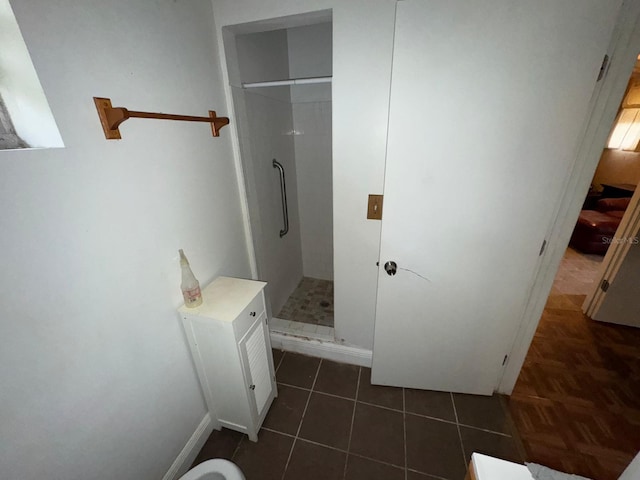 bathroom featuring walk in shower and tile patterned flooring