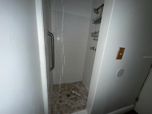 bathroom with tiled shower