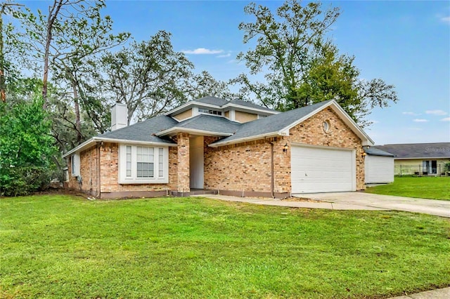 view of front of property featuring a garage and a front lawn