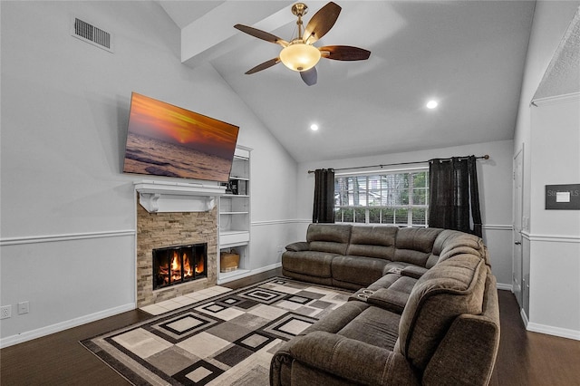 living room featuring vaulted ceiling with beams, a stone fireplace, built in features, and hardwood / wood-style floors