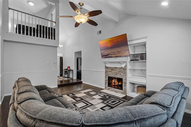 living room featuring built in shelves, a stone fireplace, high vaulted ceiling, and dark hardwood / wood-style floors