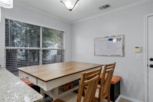 dining room featuring ornamental molding