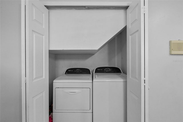 clothes washing area with washing machine and clothes dryer