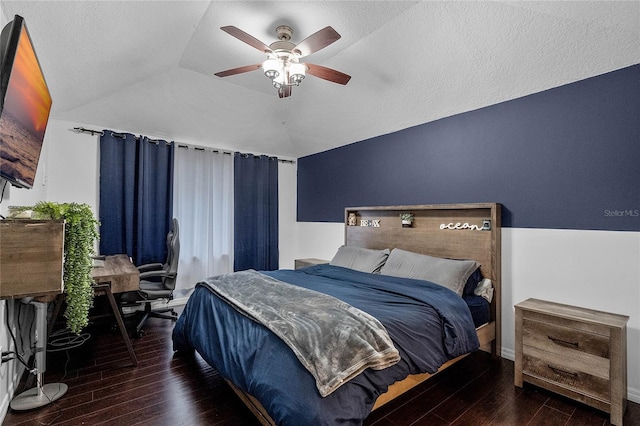 bedroom featuring dark hardwood / wood-style flooring, lofted ceiling, and ceiling fan