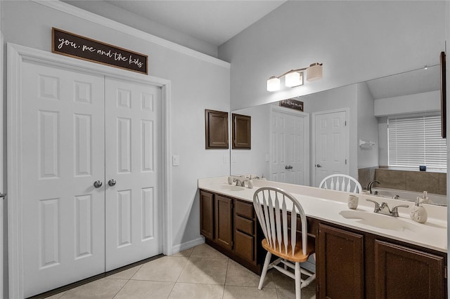 bathroom with vanity, a bath, and tile patterned floors