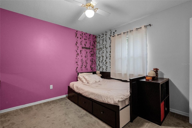 bedroom featuring light carpet and ceiling fan