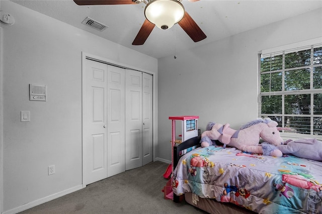 carpeted bedroom with a closet and ceiling fan