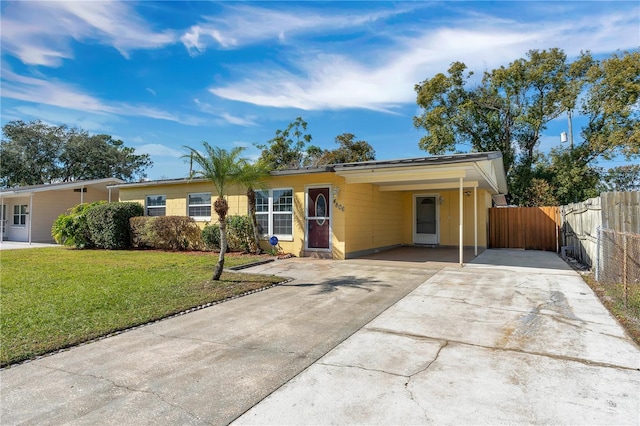 single story home featuring a carport and a front yard