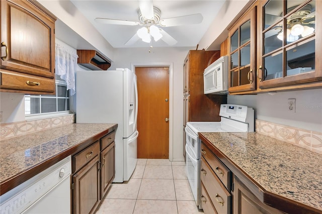 kitchen featuring ceiling fan, white appliances, and light tile patterned floors